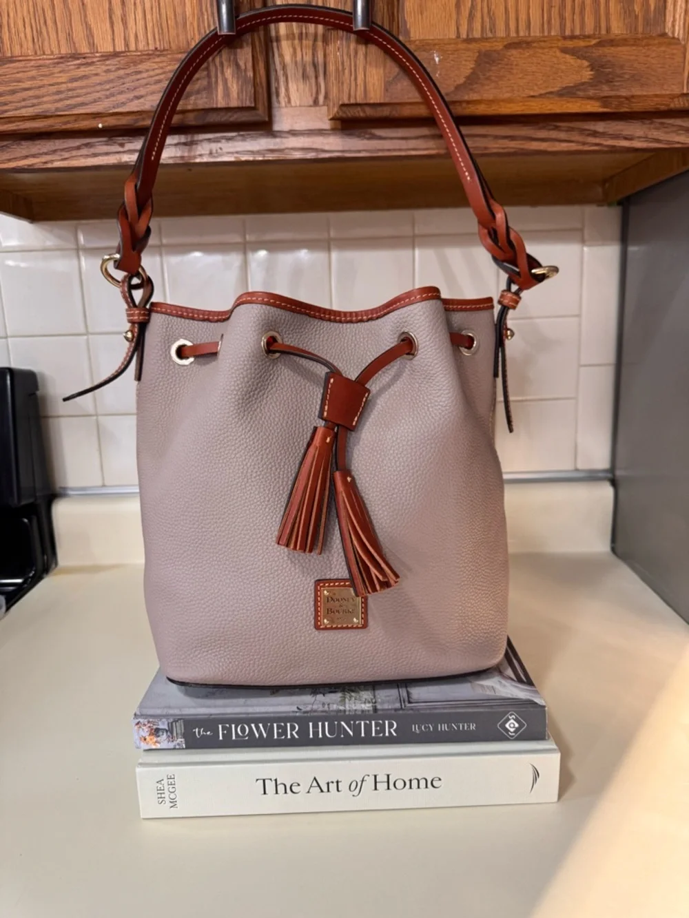 Dooney & Bourke Taupe Pebbled Leather Drawstring Bucket Bag with Brown Trim - Picture 1 of 5
